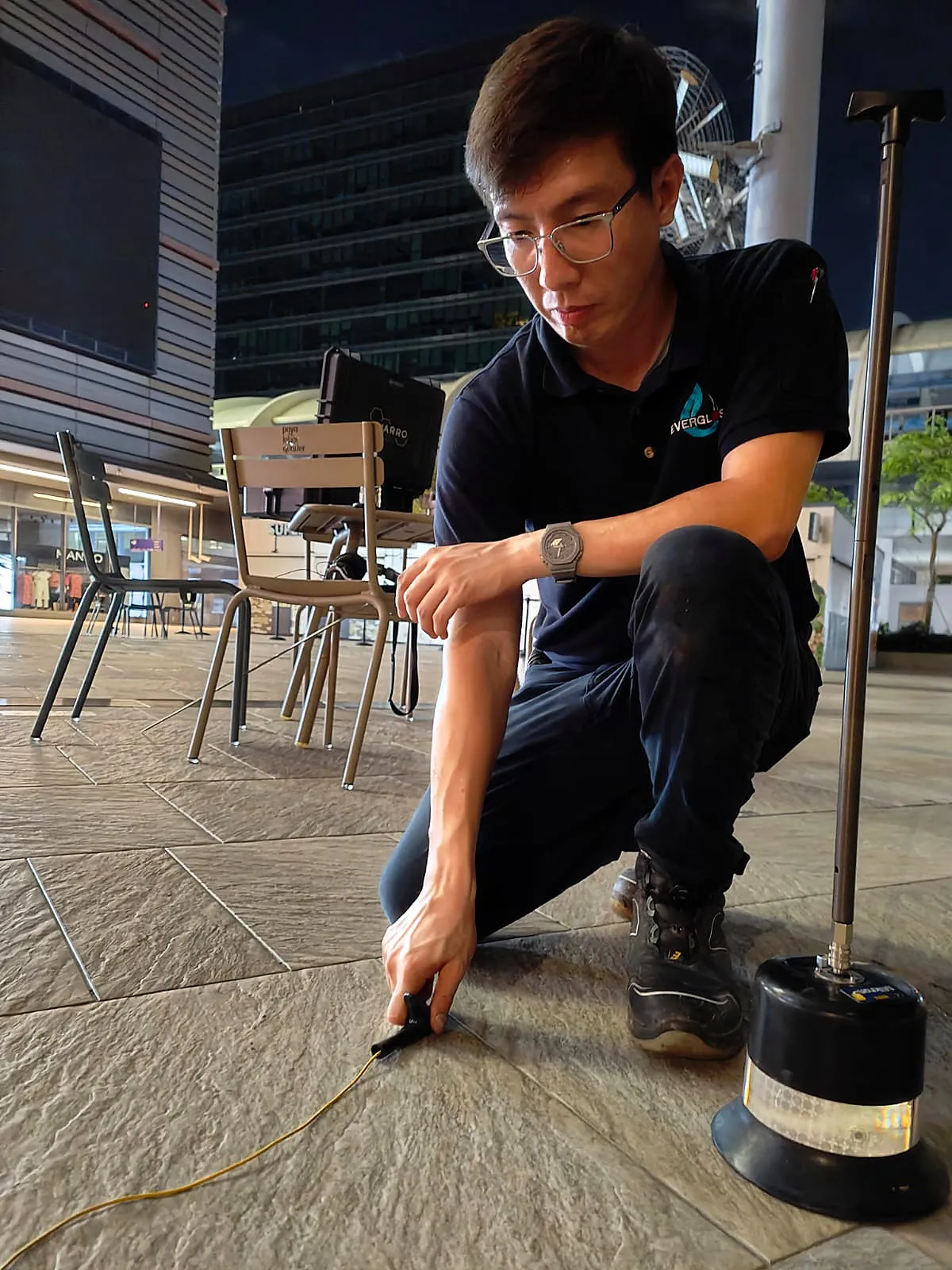 Evergloss field technician positioning a ground-listening microphone during a site inspection