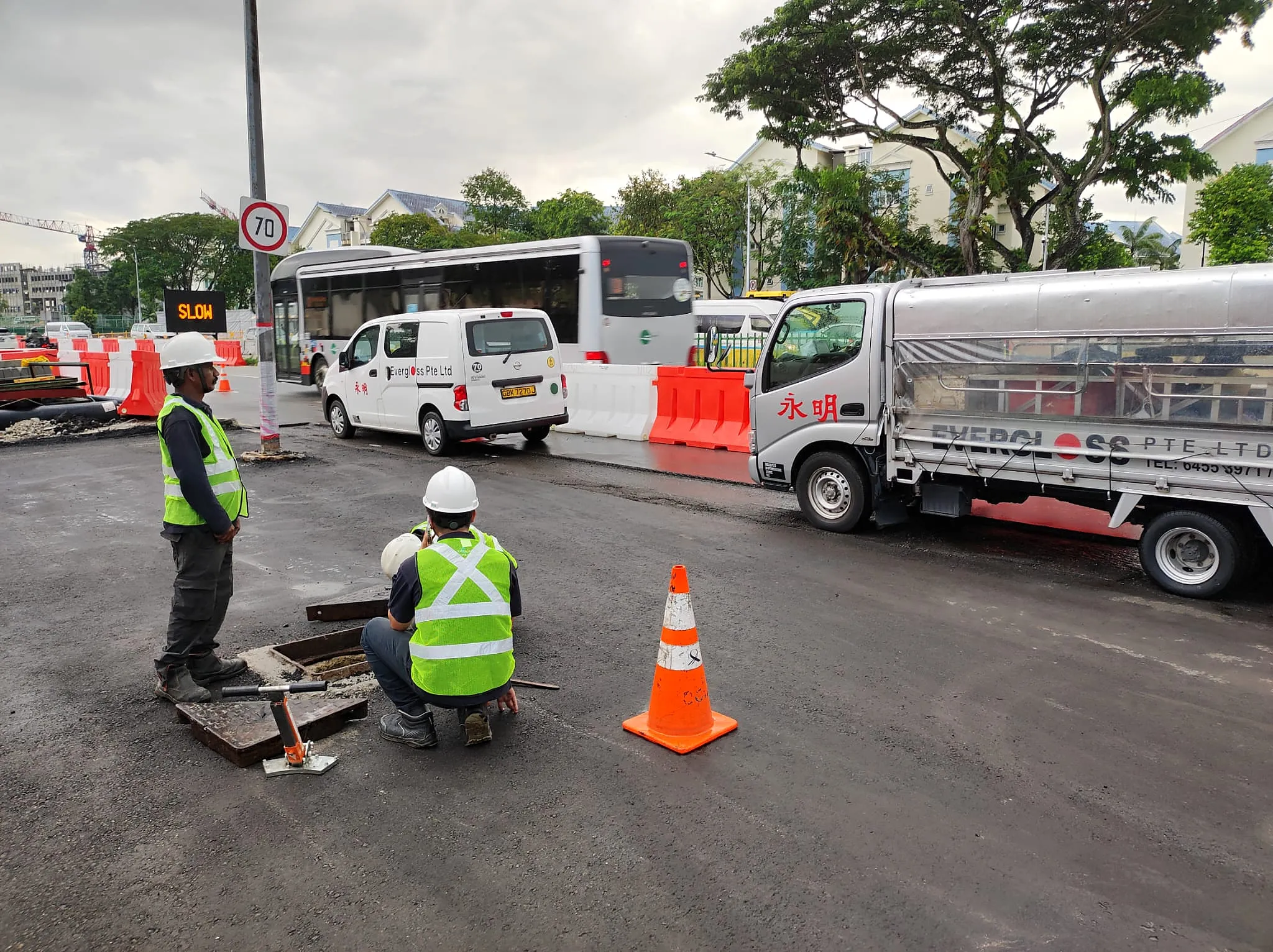 Evergloss personnel with a lorry and van at an urban roadworks site
